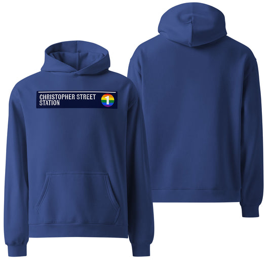 An oversized hoodie in a vibrant cobalt blue color, displayed against a plain backdrop to highlight its relaxed fit and soft texture. The front features a minimalistic "Christopher Street Station" text design.